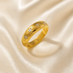 Celeste Star Band in 18 carat gold plated stainless steel with engraved star motifs and crystals.