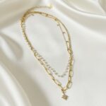 Lunar Cascade Layered Necklace with moon charms, crystal beads, and star pendant in 18 carat gold plating.