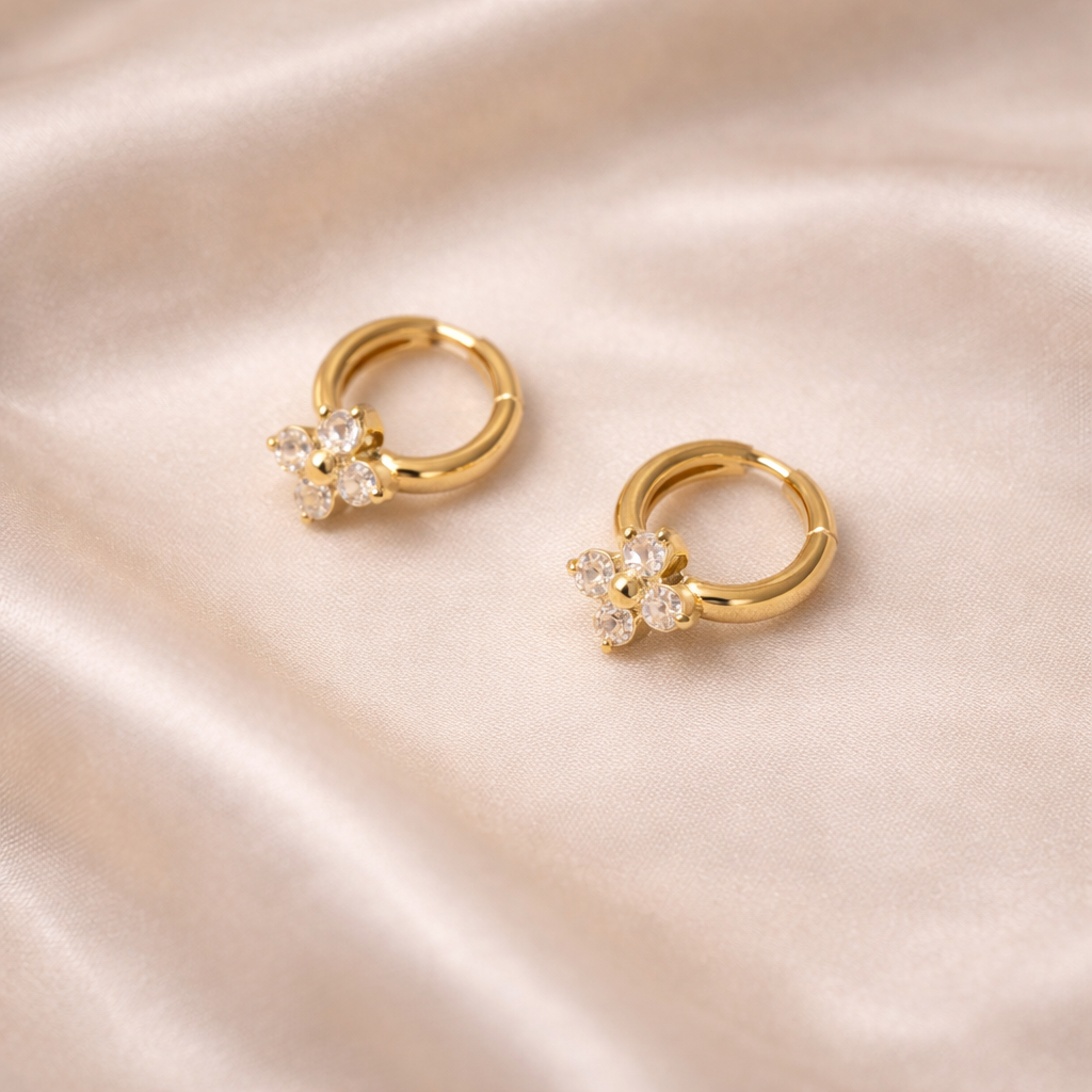 Lunelle Bloom Huggie Earrings | 18 Carat Gold Plated Floral Hoops Gold floral huggie earrings with clear zircon in stainless steel with 18 carat gold plating, anti-tarnish and hypoallergenic